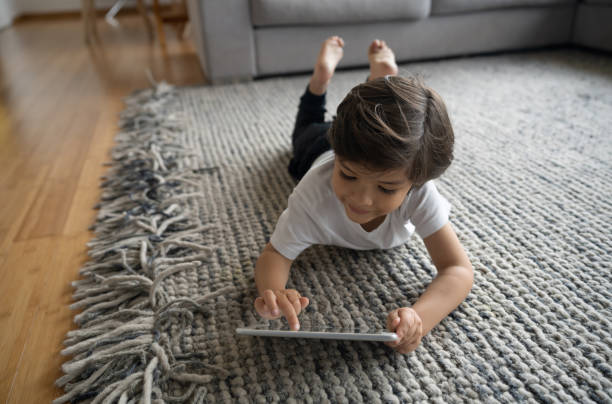 Girl lying on carpet | Signature Flooring, Inc